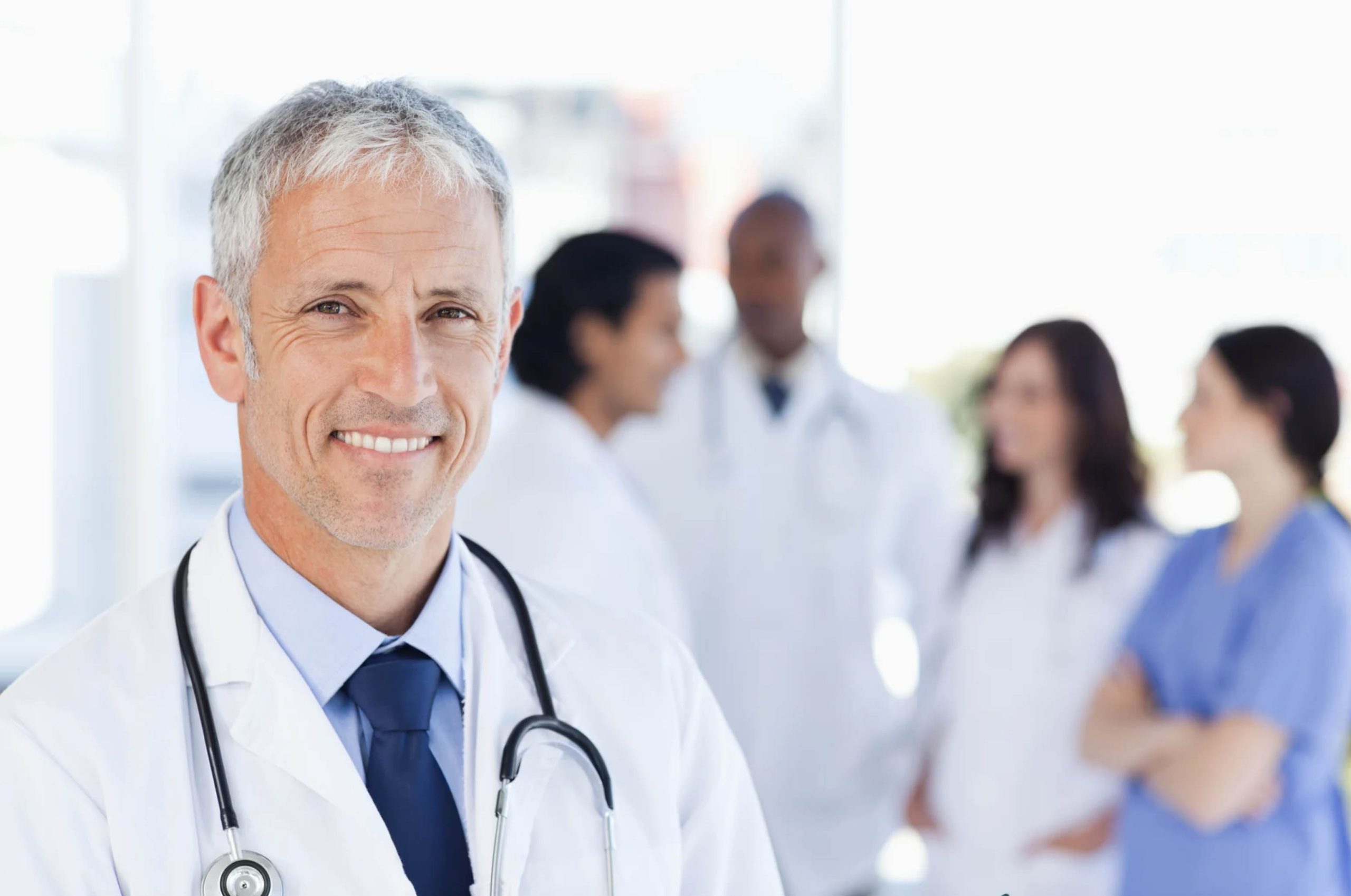 ACGrace - A doctor standing in front of a group of people.