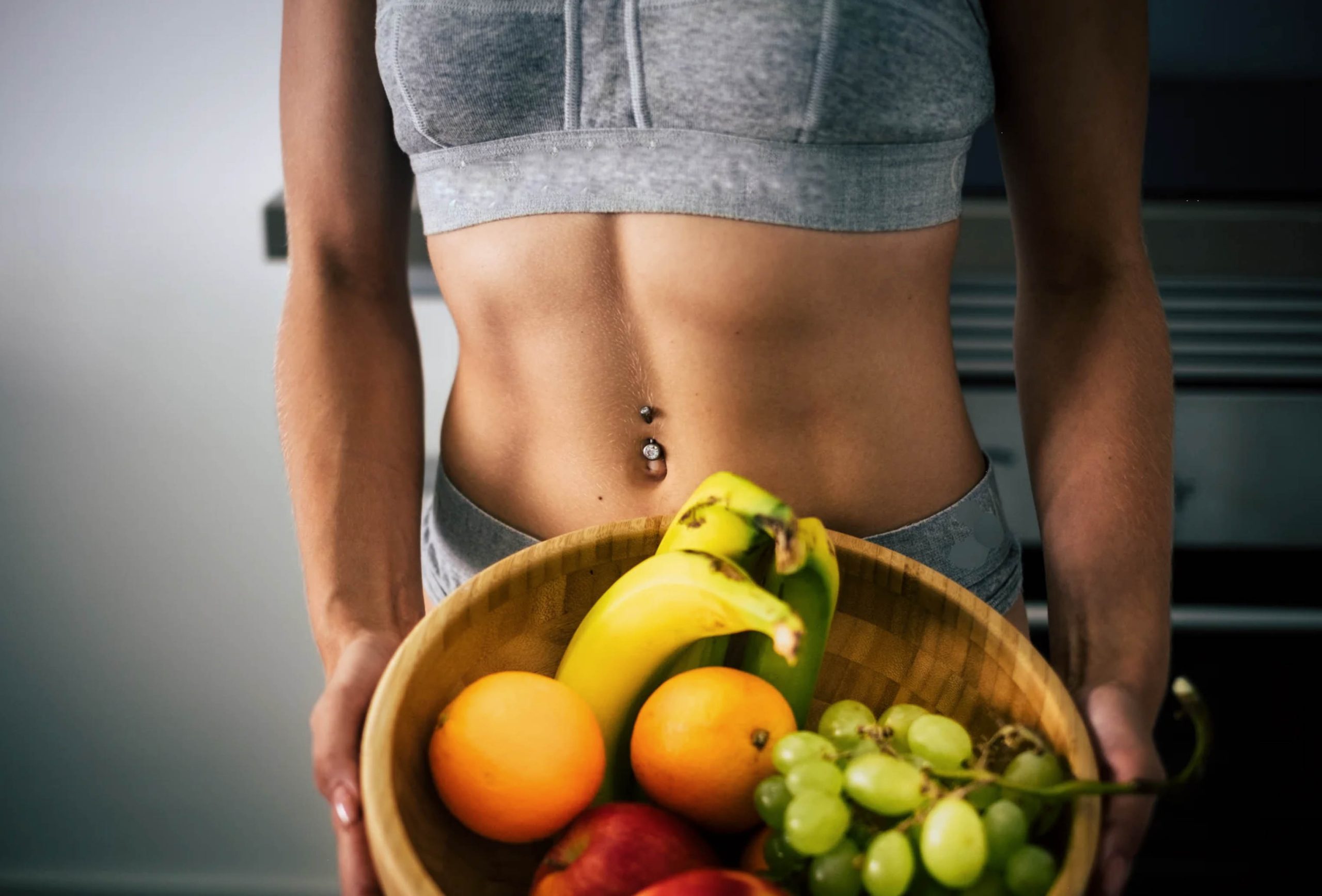 ACGrace - A woman is holding a bowl of fruit.