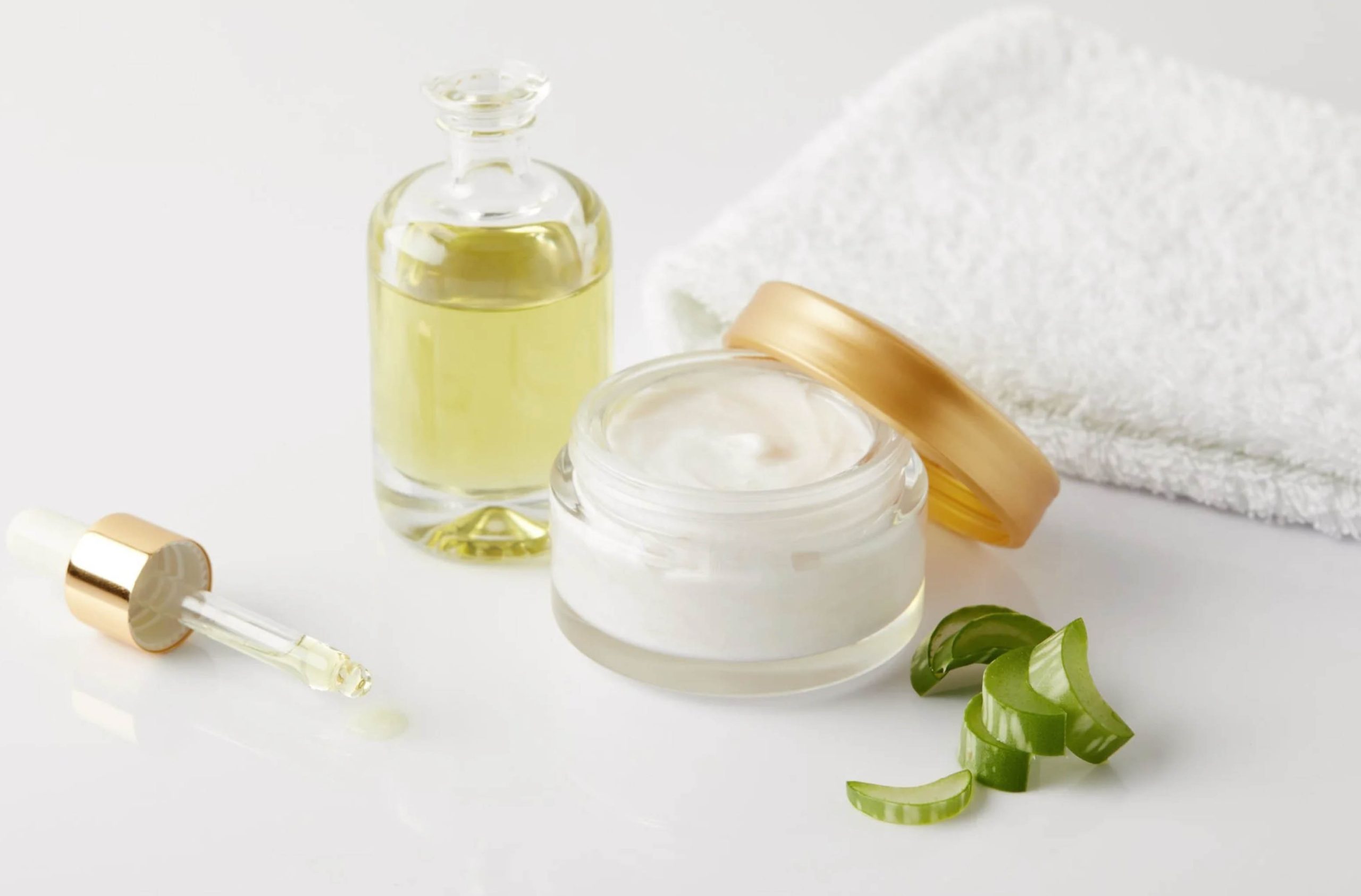ACGrace - Aloe vera cream and a bottle of oil on a white surface.