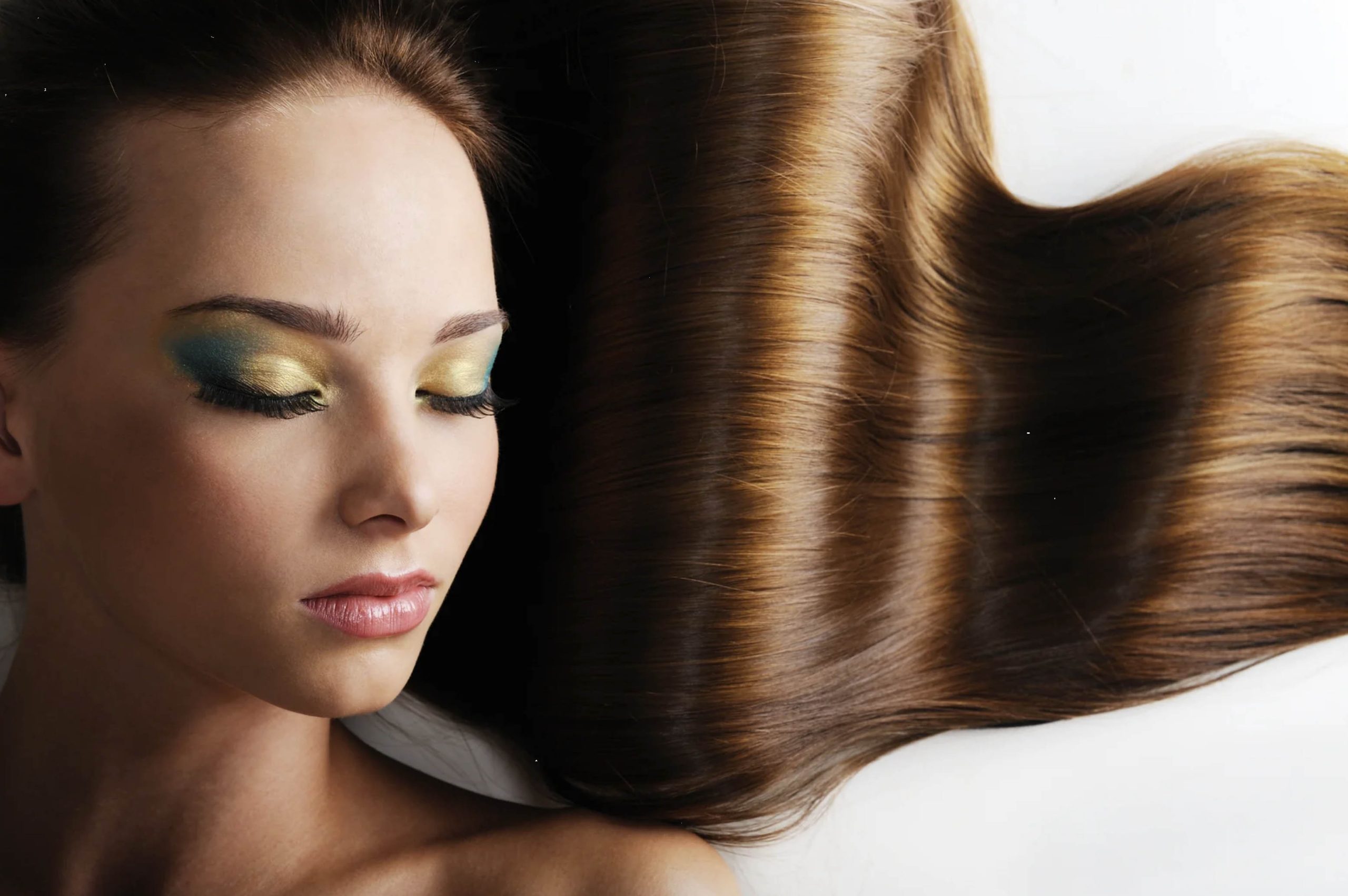 ACGrace - A woman with long brown hair is laying on a bed.
