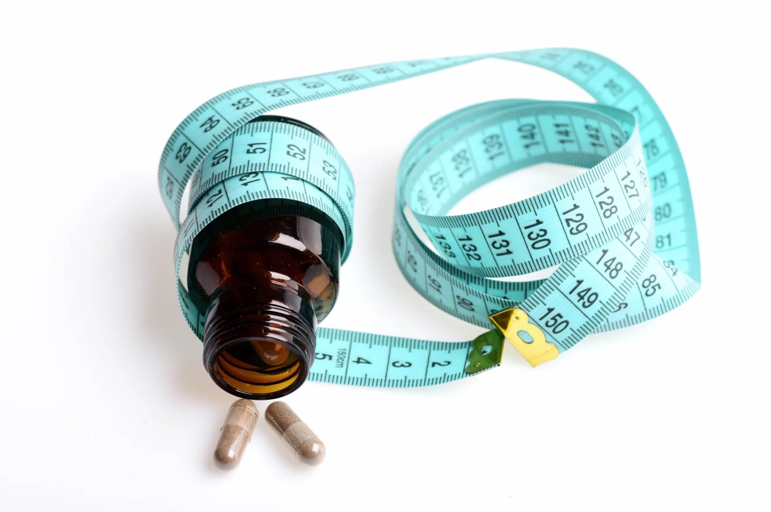 ACGrace - A bottle of pills and a measuring tape on a white background.